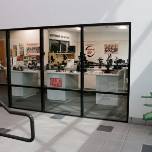 To your right, as you enter the building the showroom can be seen through a glass wall. Displayed are both the standard tool line and the new line of industrial slides and spindles.